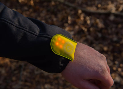 a person wearing a yellow wristband with a yellow light on it
