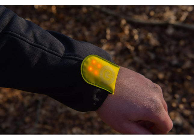 a person wearing a yellow wristband with a yellow light on it